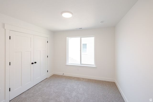 195 West Harmony Rdg Parkway, Unit 601 Mapleton, UT 84664 - Photo 19 of 23 Bedroom featuring neutral carpeting, white walls, and a window with white trim