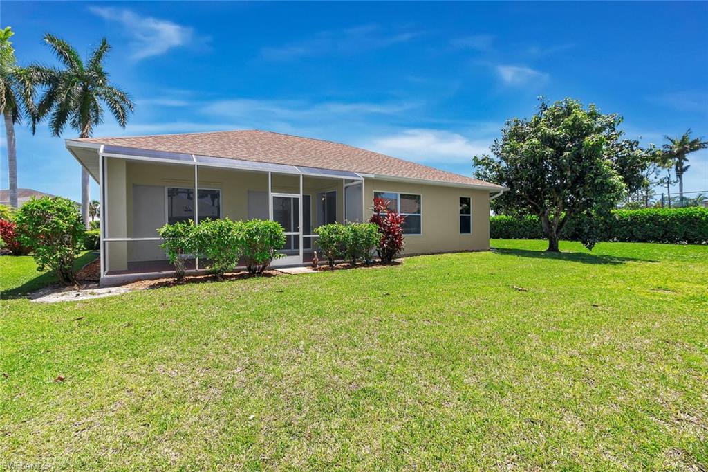 2389 Piccadilly Circus Naples, FL 34112 - Photo 14 of 21 a front view of house with yard and green space