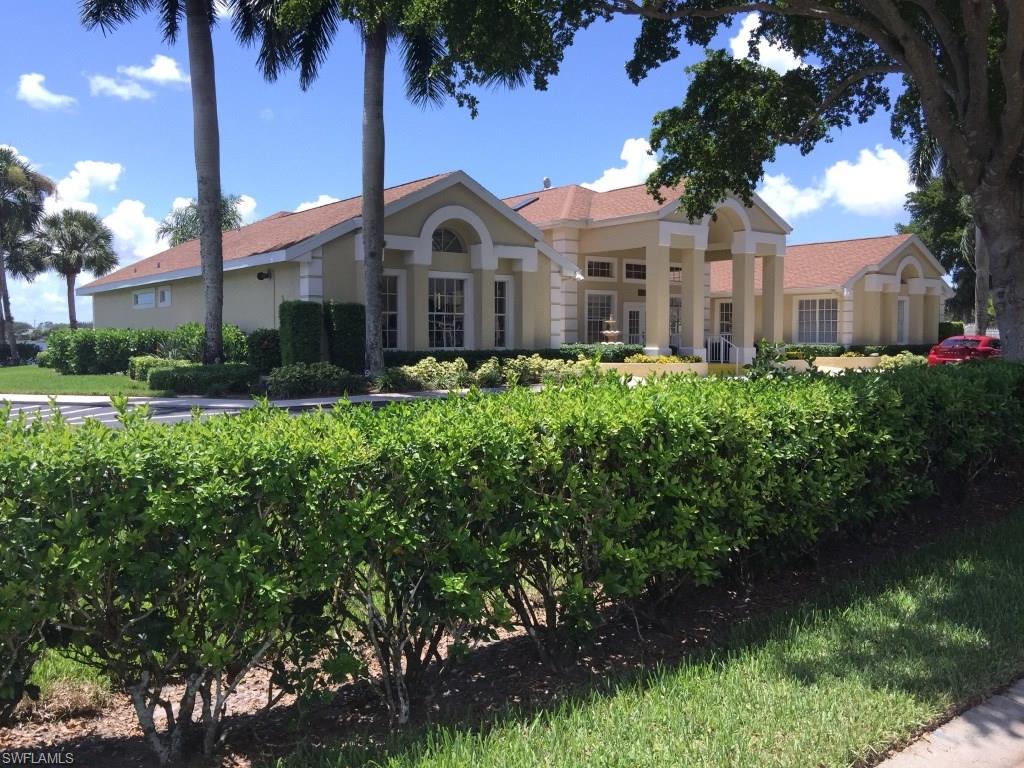 2389 Piccadilly Circus Naples, FL 34112 - Photo 16 of 21 a front view of a house with a yard and garage