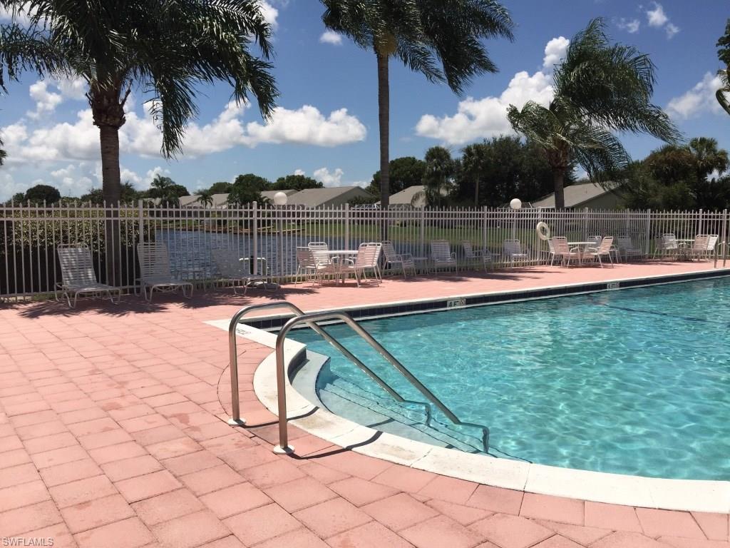 2389 Piccadilly Circus Naples, FL 34112 - Photo 20 of 21 a swimming pool with outdoor seating and yard