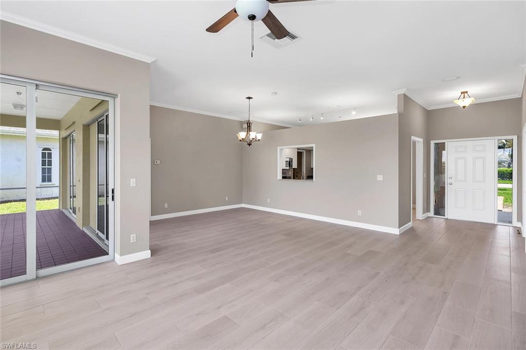 2389 Piccadilly Circus Naples, FL 34112 - Photo 2 of 21 a view of an empty room with window and wooden floor