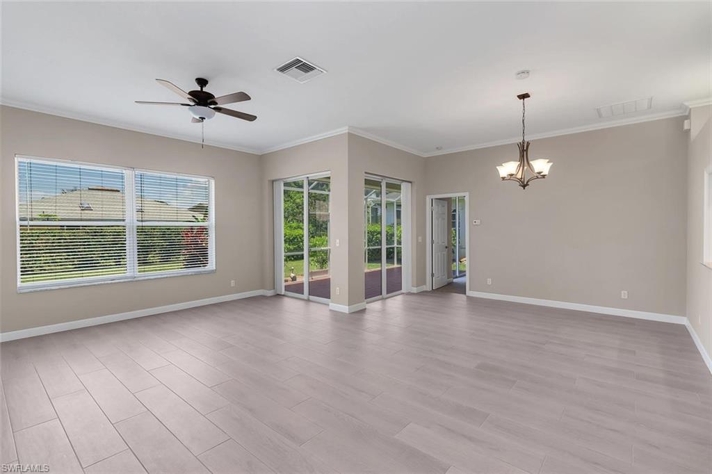 2389 Piccadilly Circus Naples, FL 34112 - Photo 9 of 21 a view of an empty room with a window and wooden floor