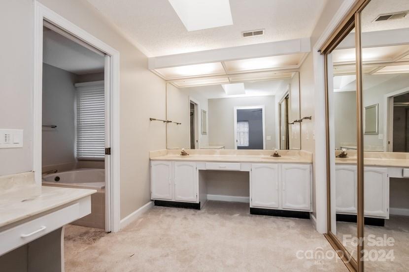 9325 Raintree Lane Charlotte, NC 28277 - Photo 13 of 15 a large bathroom with a double vanity sink mirror and a bathtub