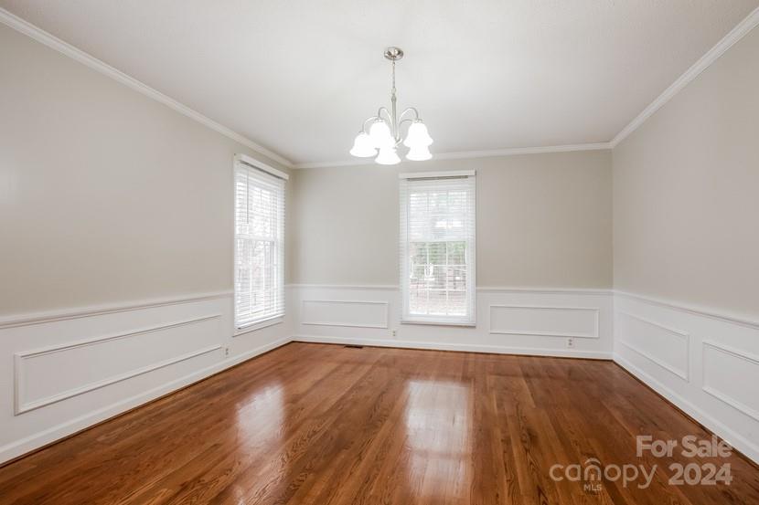 9325 Raintree Lane Charlotte, NC 28277 - Photo 3 of 15 wooden floor in an empty room with a window