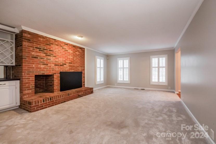 9325 Raintree Lane Charlotte, NC 28277 - Photo 8 of 15 a view of an empty room with a fireplace and a window