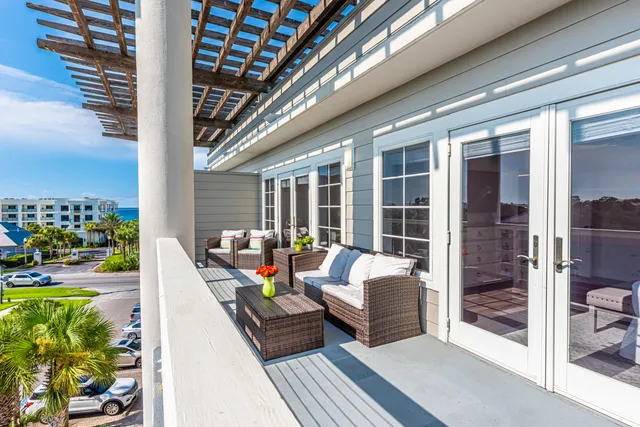 a balcony with furniture and a potted plant
