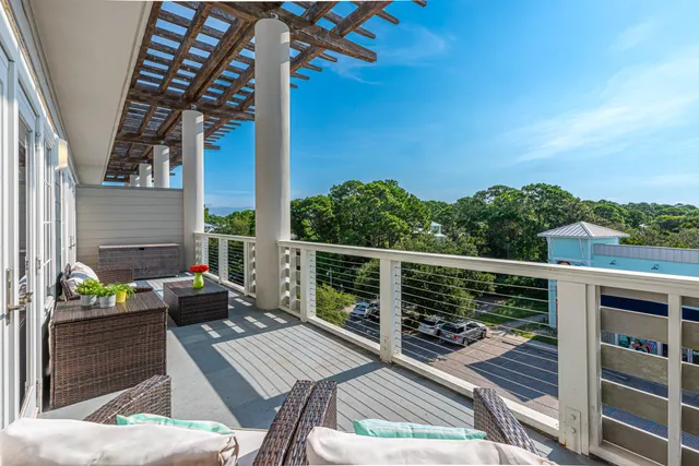 a view of balcony with wooden floor and outdoor seating
