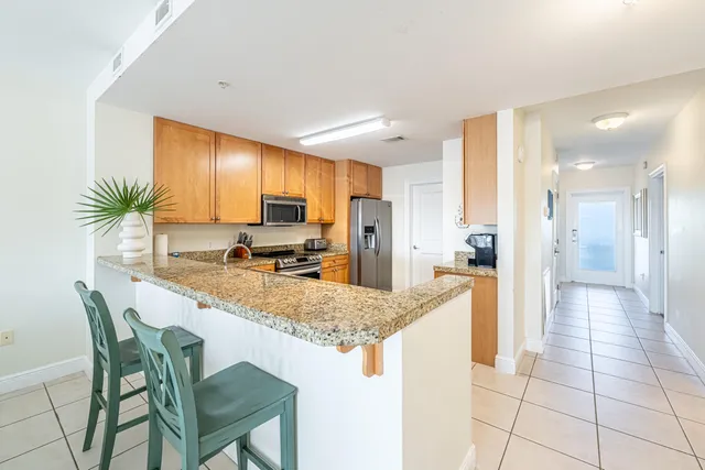 a kitchen with a stove a sink and a refrigerator