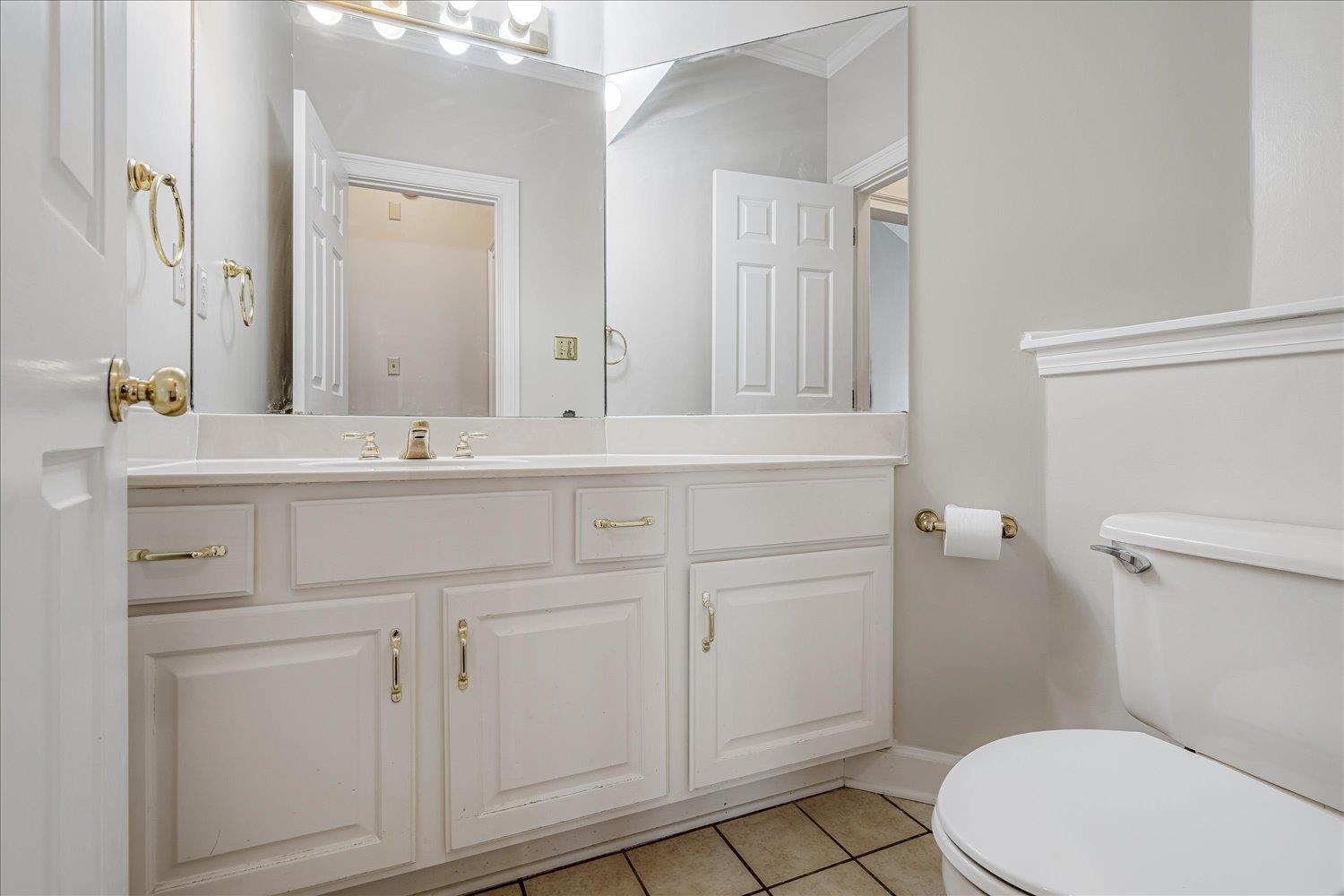 4821 Kingsgate Place South Memphis, TN 38117 - Photo 12 of 19 a bathroom with a sink a toilet a vanity and mirror