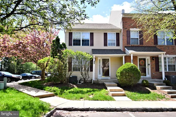 a front view of a house with a yard and outdoor seating
