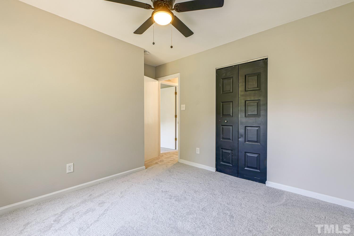 2409 Village Grove Road Raleigh, NC 27613 - Photo 12 of 18 an empty room with closet and windows