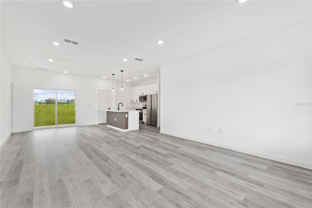 925 Desmoines Way Poinciana, FL 34759 - Photo 14 of 40 a view of empty room with wooden floor