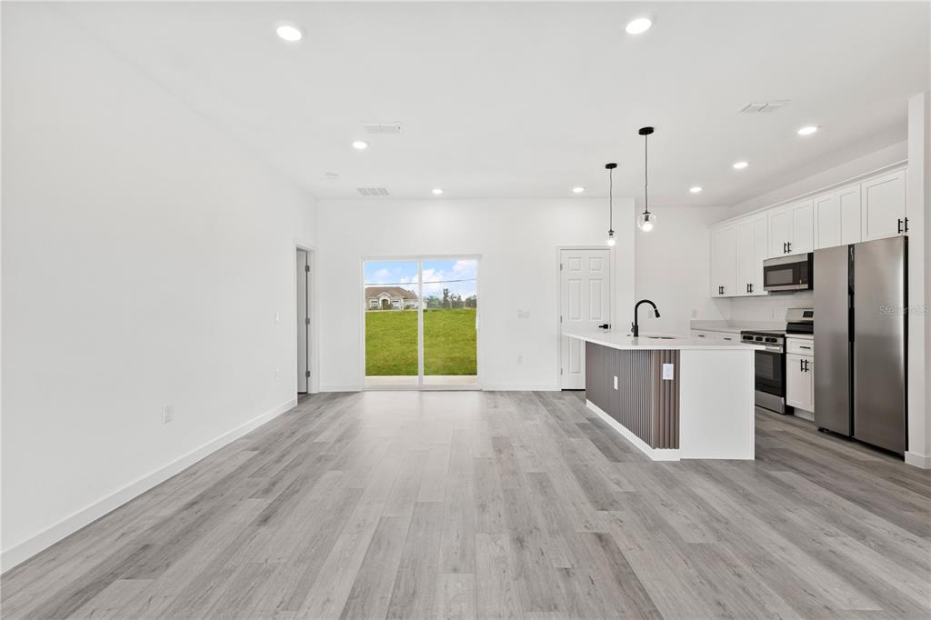 925 Desmoines Way Poinciana, FL 34759 - Photo 18 of 40 a view of kitchen with stainless steel appliances granite countertop a refrigerator a sink a stove and a wooden floors
