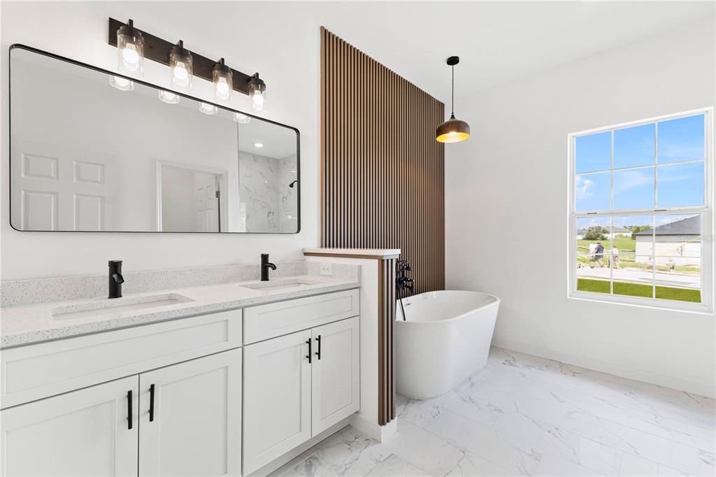 925 Desmoines Way Poinciana, FL 34759 - Photo 22 of 40 a bathroom with a double vanity sink a toilet and a mirror