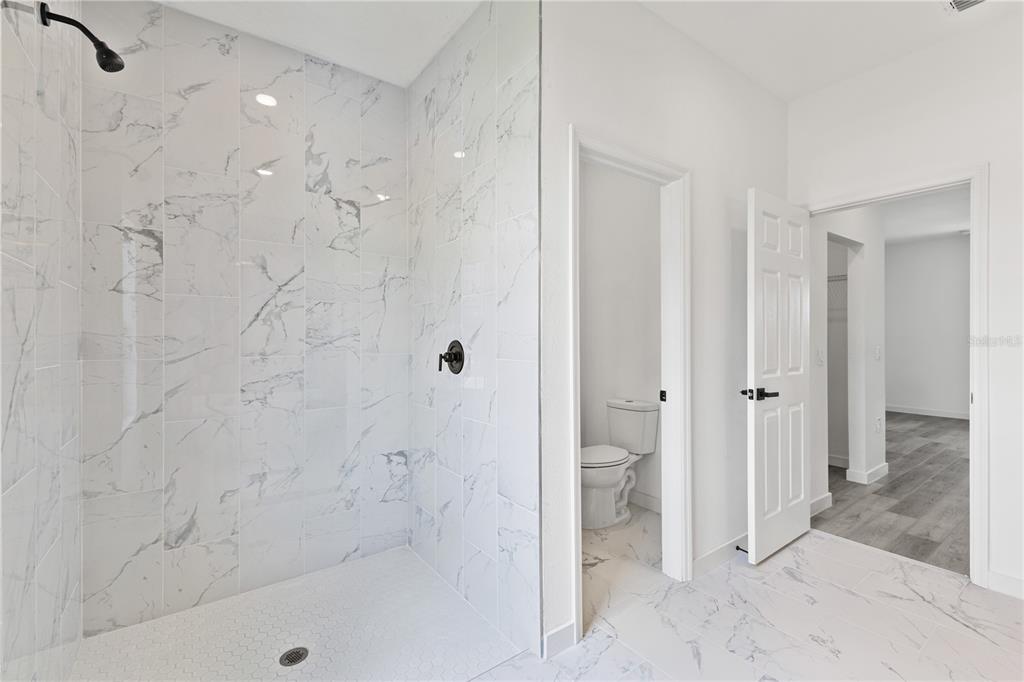 925 Desmoines Way Poinciana, FL 34759 - Photo 24 of 40 a bathroom with a bathtub and a shower