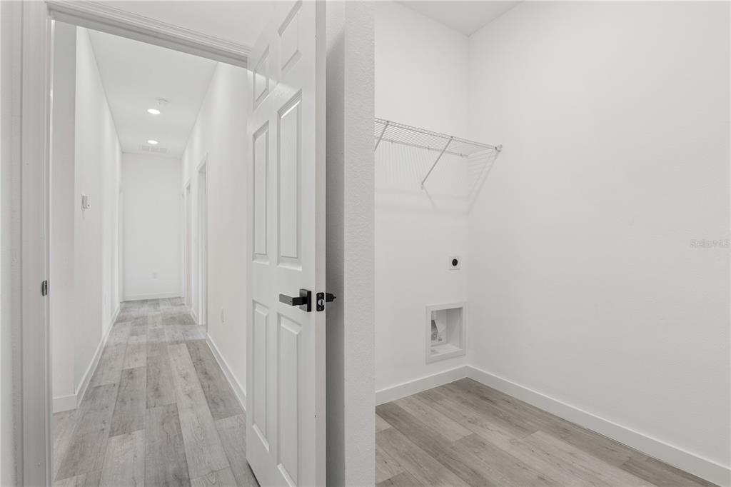 925 Desmoines Way Poinciana, FL 34759 - Photo 30 of 40 a view of a hallway with wooden floor and closet area