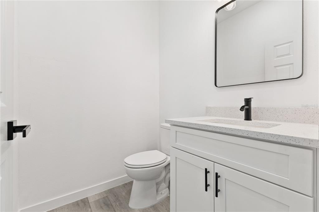 925 Desmoines Way Poinciana, FL 34759 - Photo 37 of 40 a bathroom with a toilet a sink and mirror