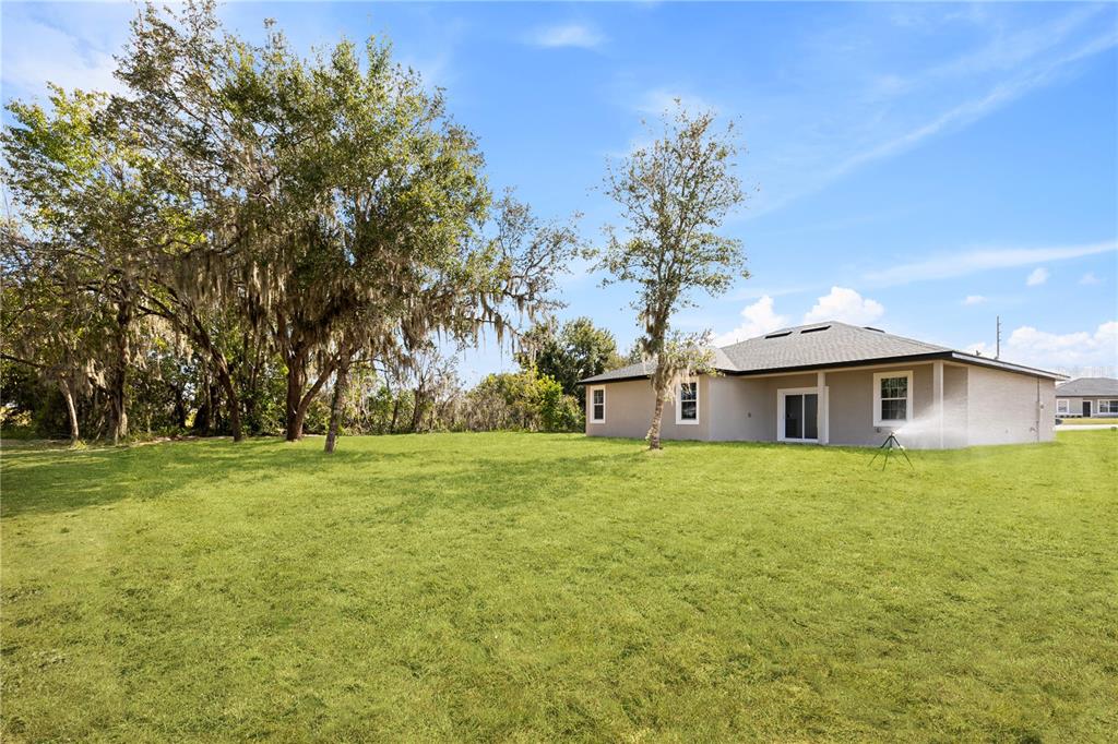 925 Desmoines Way Poinciana, FL 34759 - Photo 8 of 40 a front view of a house with a garden