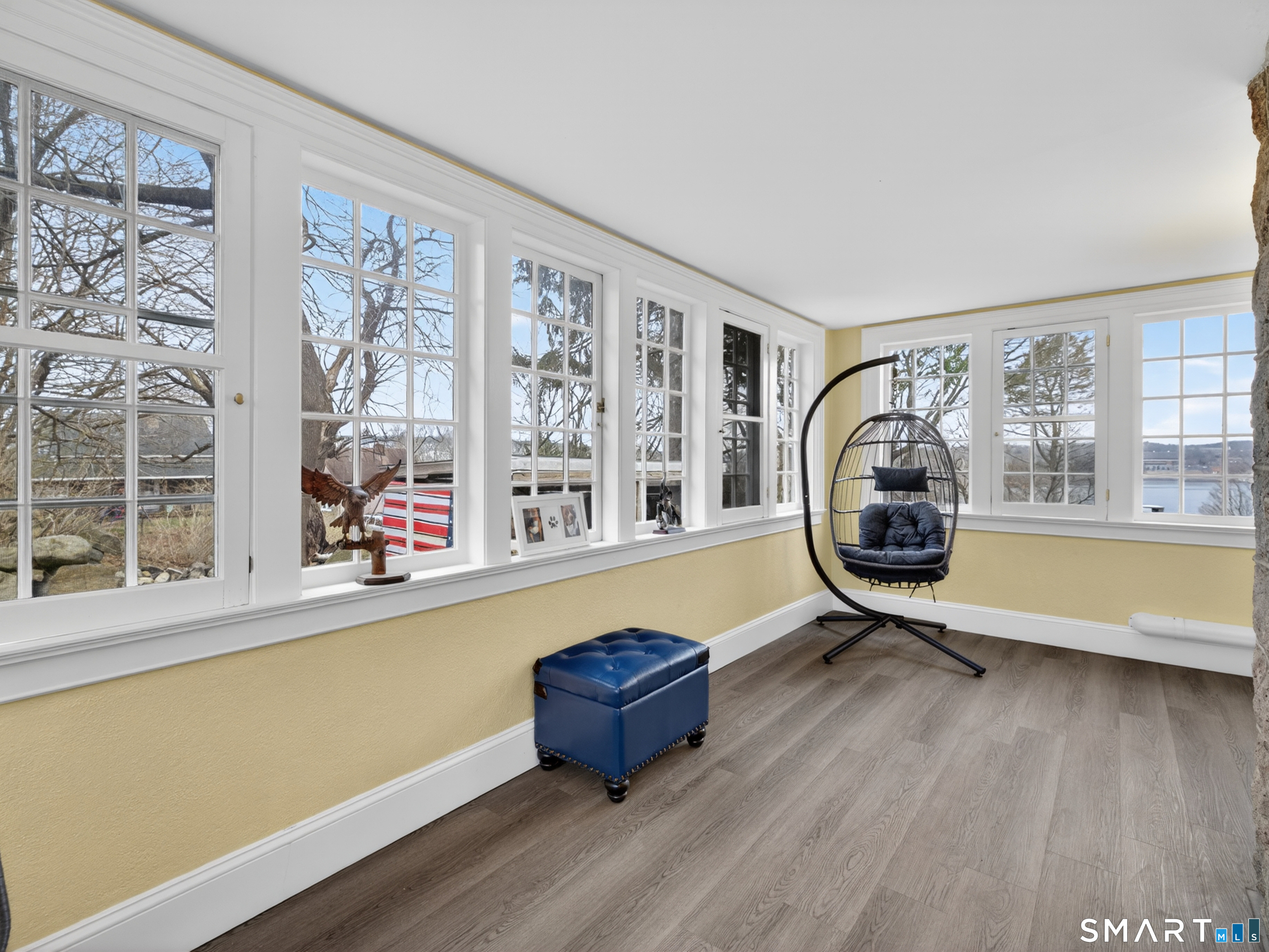 76 Starr Hill Road Groton, CT 06340 - Photo 7 of 40 a living room with a large window and a wooden floor
