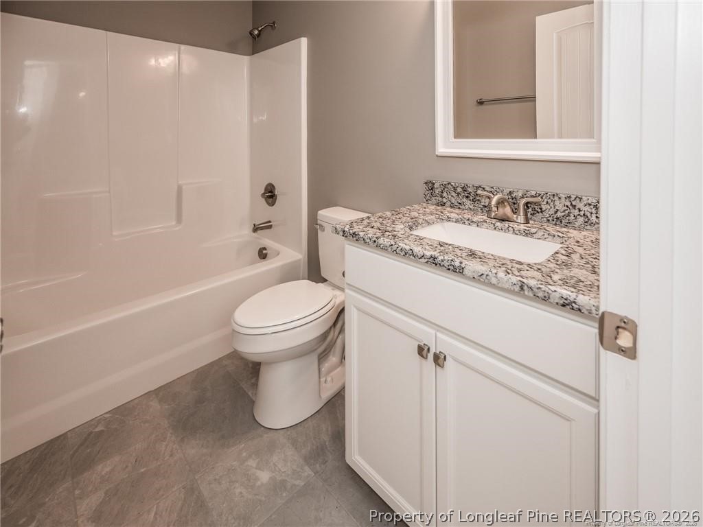 1102 West Carthage Road Lumberton, NC 28360 - Photo 30 of 41 a bathroom with a granite countertop sink toilet and shower