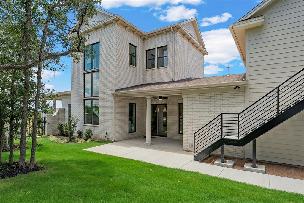 20 Ritchie Road Woodway, TX 76712 - Photo 31 of 40 White brick exterior with a covered patio, black framed windows, and a metal outdoor staircase