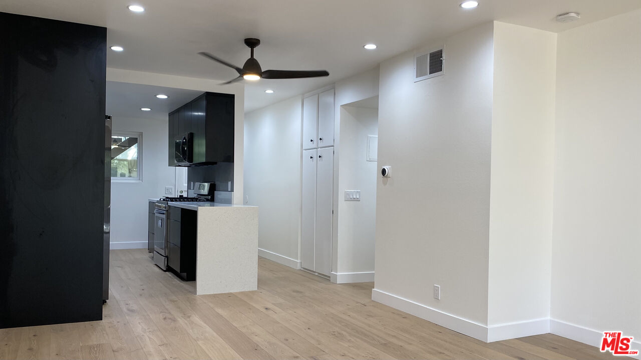 6474 Cavalleri Road Malibu, CA 90265 - Photo 13 of 24 a kitchen with white cabinets and stainless steel appliances