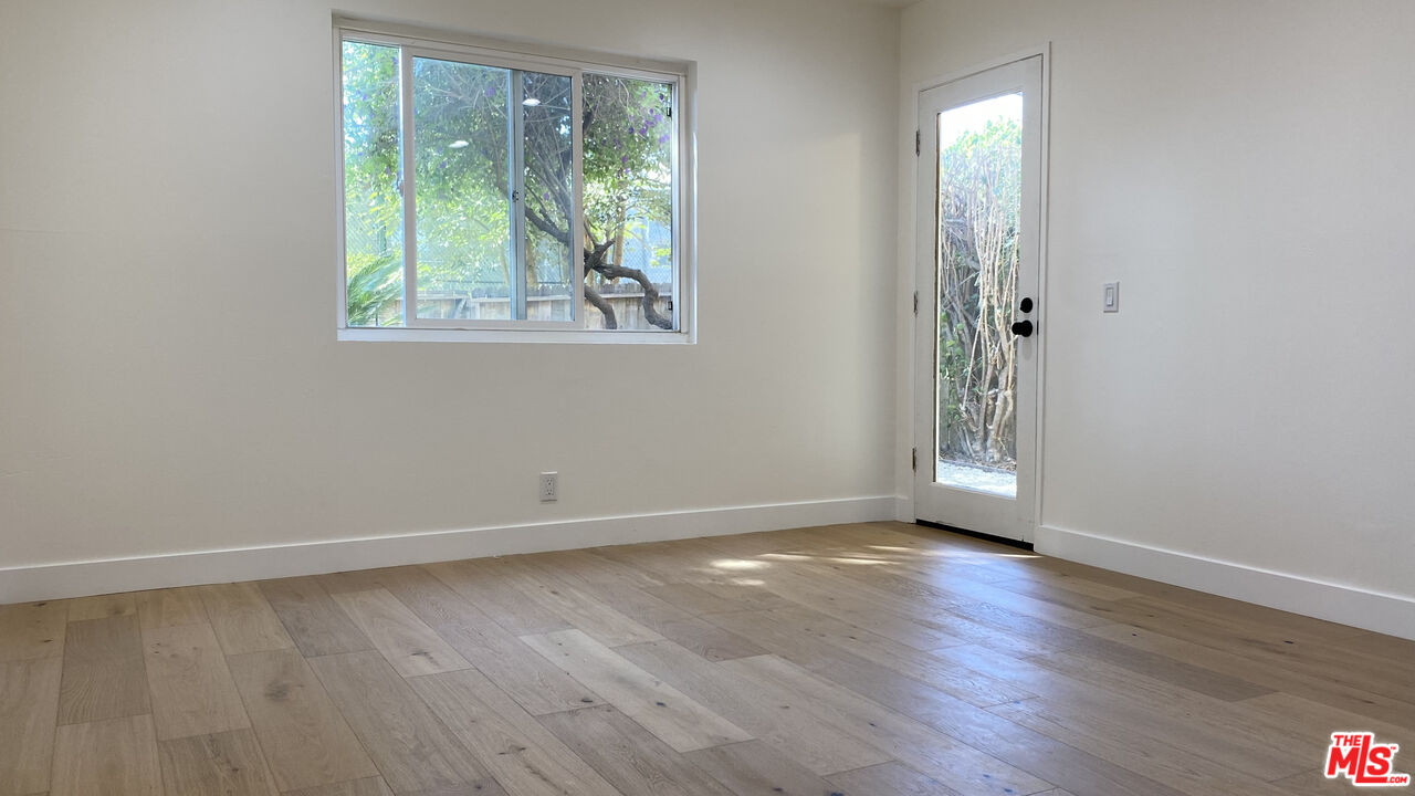 6474 Cavalleri Road Malibu, CA 90265 - Photo 17 of 24 an empty room with wooden floor and windows