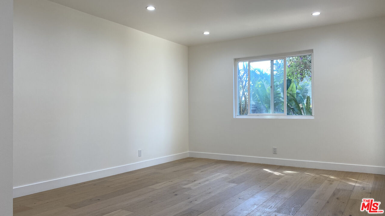 6474 Cavalleri Road Malibu, CA 90265 - Photo 20 of 24 a view of an empty room with wooden floor and a window