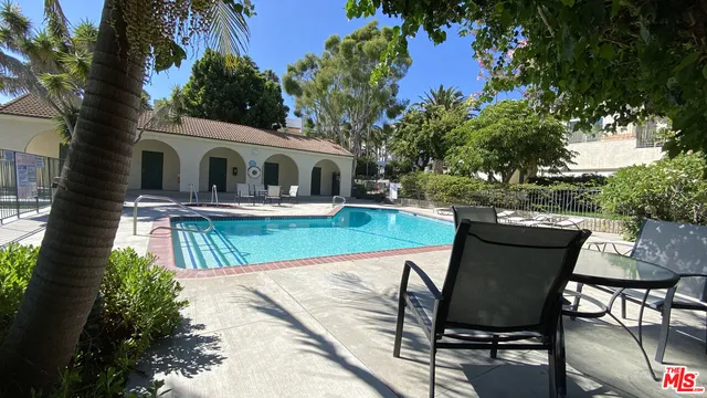 a view of house with outdoor seating and garden
