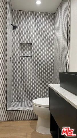 a bathroom with a toilet and a shower