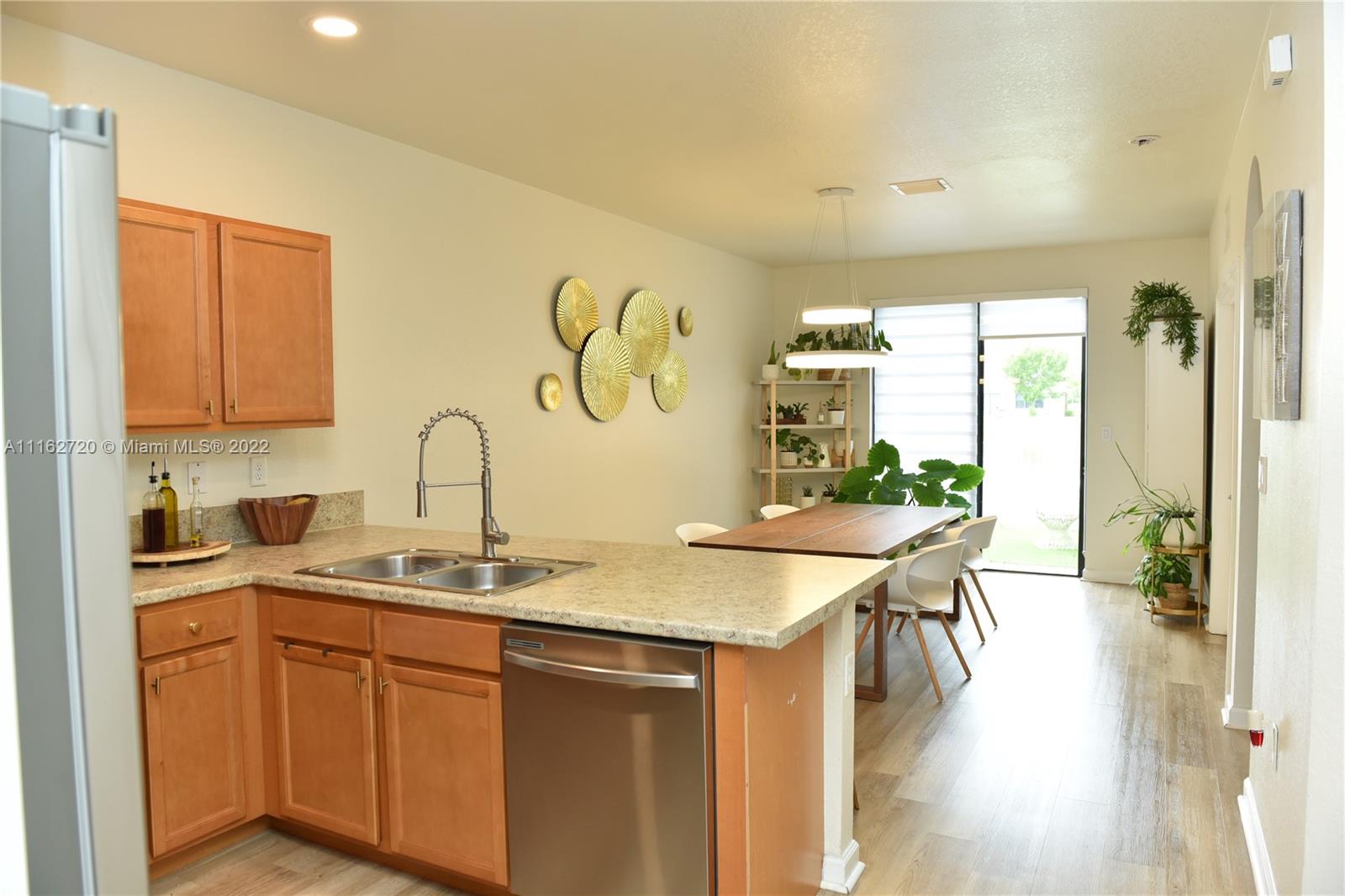 Hialeah Hialeah, FL 33018 - Photo 13 of 60 a kitchen with stainless steel appliances granite countertop a sink a stove and wooden floor