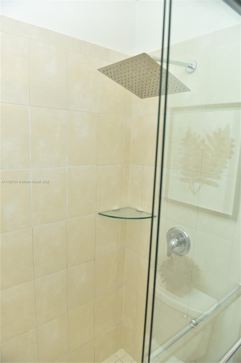 Hialeah Hialeah, FL 33018 - Photo 19 of 60 a bathroom with a glass shower door