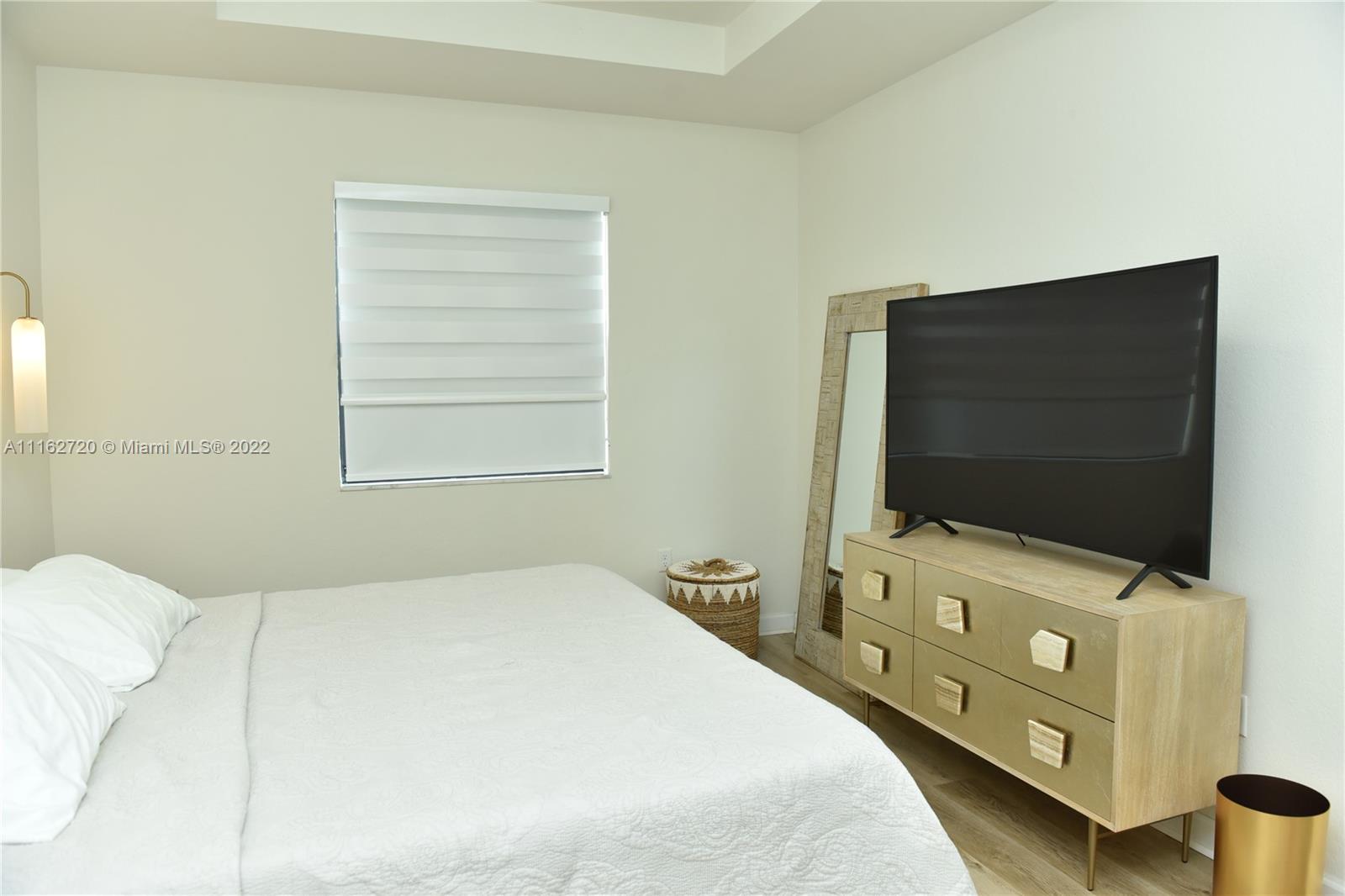Hialeah Hialeah, FL 33018 - Photo 25 of 60 a bedroom with a bed and a flat screen tv