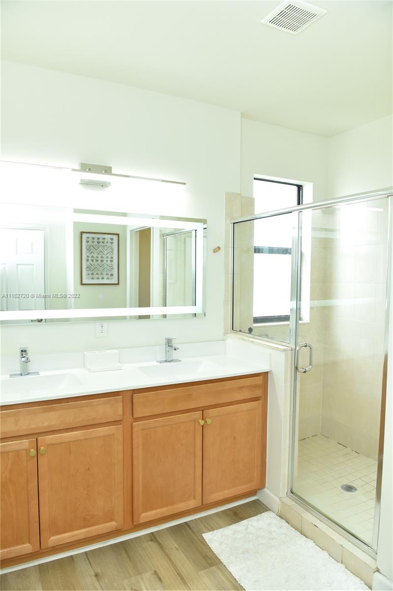 Hialeah Hialeah, FL 33018 - Photo 31 of 60 a bathroom with a double vanity sink mirror and shower