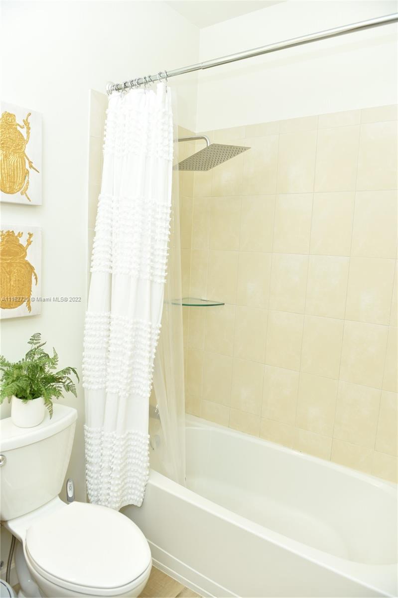 Hialeah Hialeah, FL 33018 - Photo 35 of 60 a bathroom with a shower curtain and a toilet