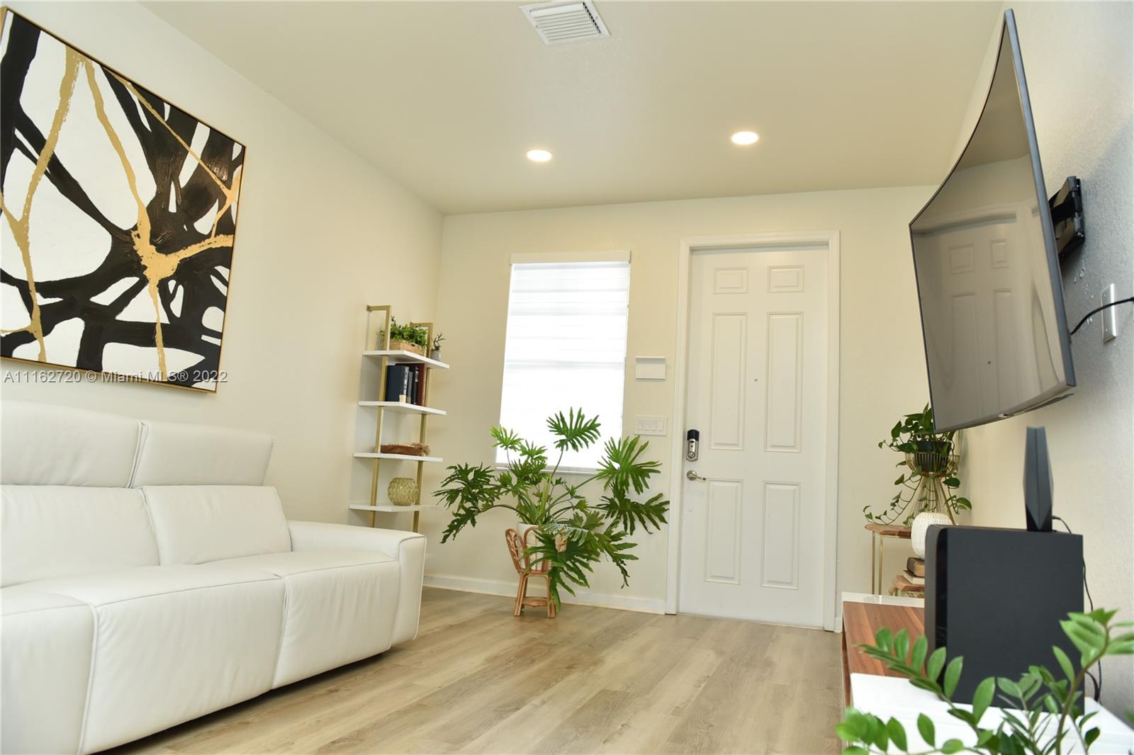 Hialeah Hialeah, FL 33018 - Photo 5 of 60 a living room with furniture and a wooden floor
