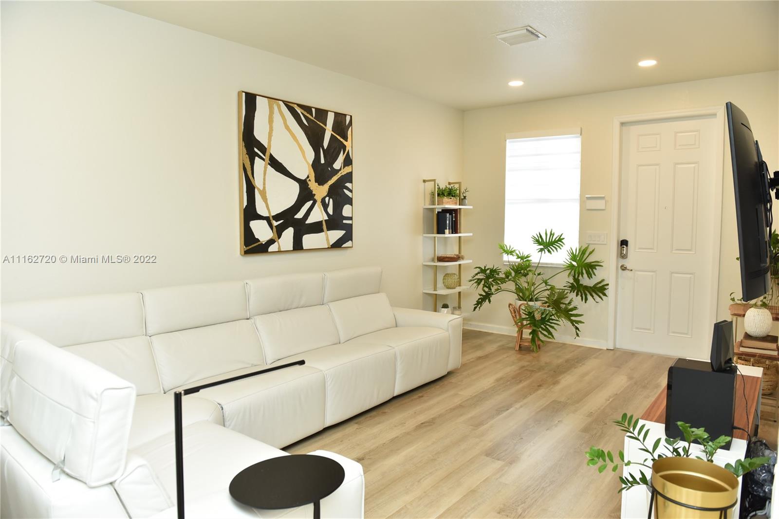 Hialeah Hialeah, FL 33018 - Photo 6 of 60 a living room with furniture and a flat screen tv