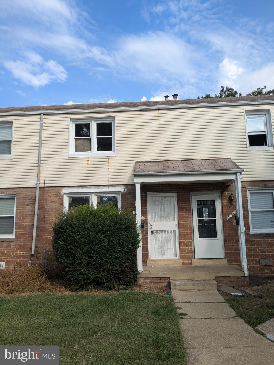 2834 Iverson Street, Unit 101 Temple Hills, MD 20748 - Photo 12 of 13 a front view of a house with a garden and garage