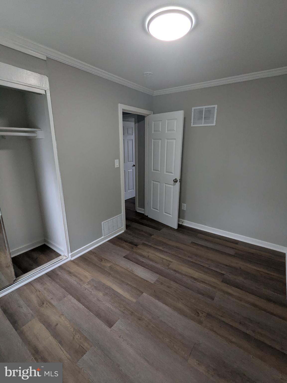 2834 Iverson Street, Unit 101 Temple Hills, MD 20748 - Photo 4 of 13 a view of a livingroom with wooden floor