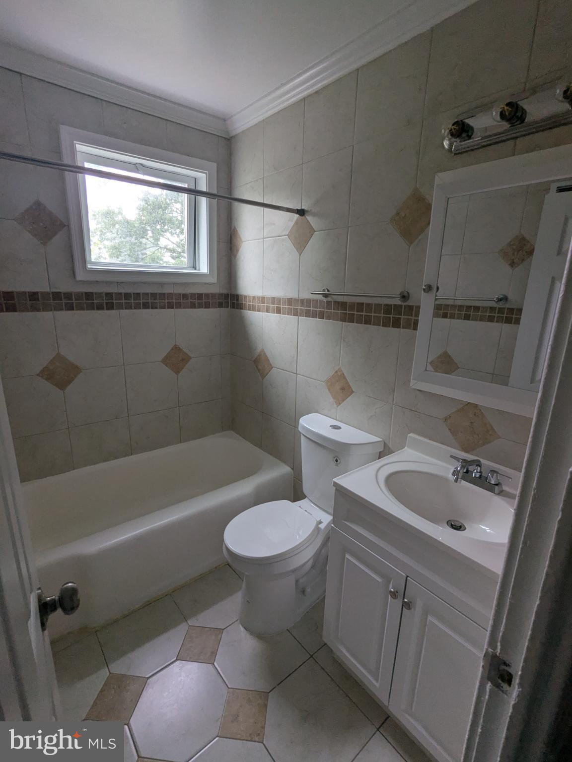 2834 Iverson Street, Unit 101 Temple Hills, MD 20748 - Photo 7 of 13 a bathroom with a sink toilet and shower