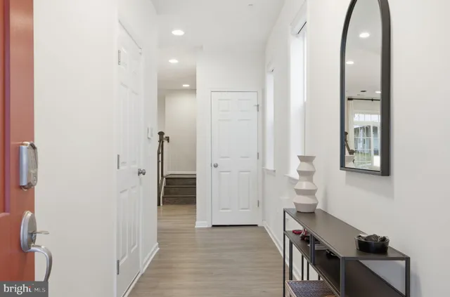 a living room with furniture a flat screen tv and a large window