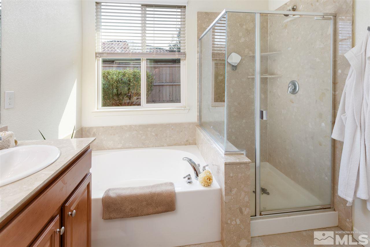 10800 Pebble Hill Drive Reno, NV 89521 - Photo 11 of 21 a bathroom with a tub sink and window