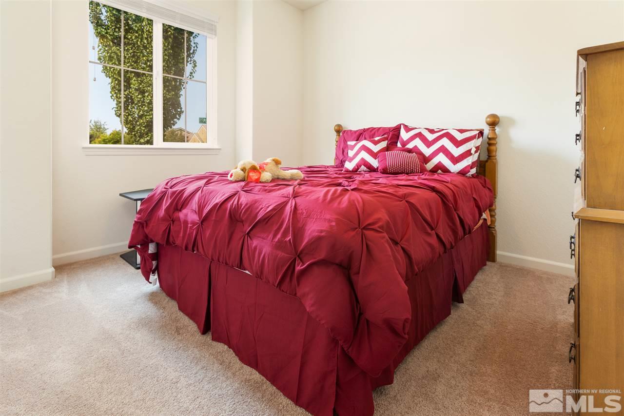 10800 Pebble Hill Drive Reno, NV 89521 - Photo 13 of 21 a bed sitting in a bedroom next to a window