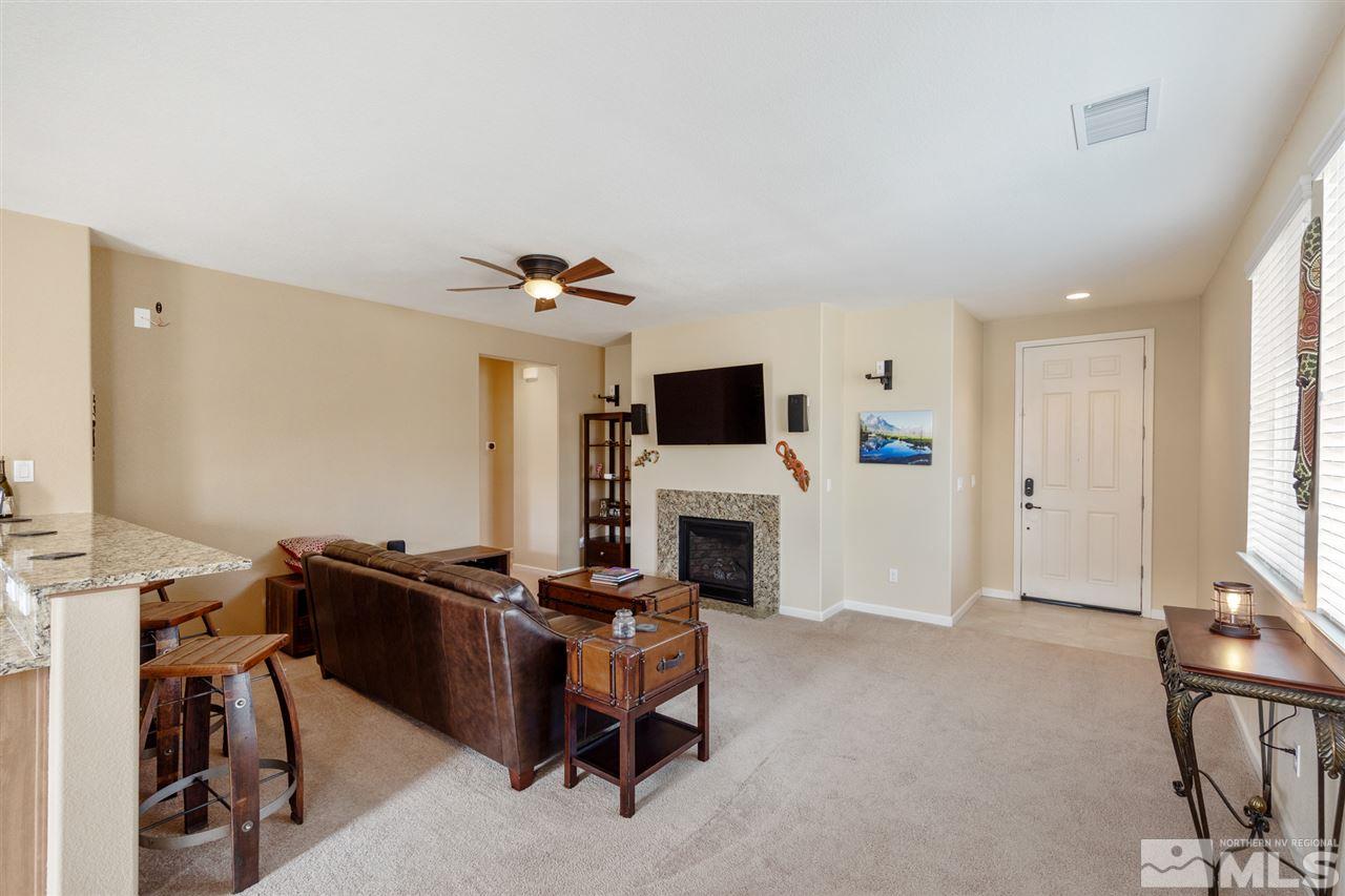 10800 Pebble Hill Drive Reno, NV 89521 - Photo 3 of 21 a living room with furniture a flat screen tv and a fireplace