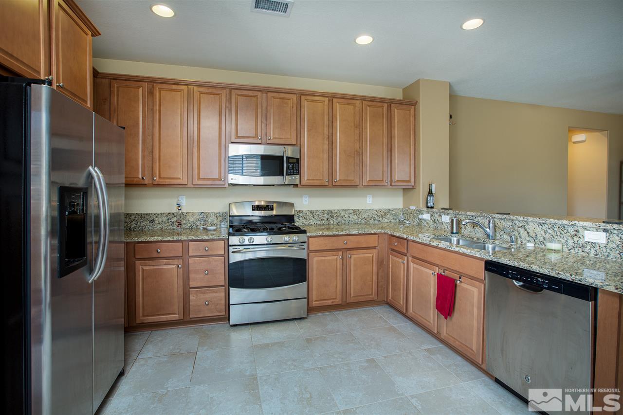 10800 Pebble Hill Drive Reno, NV 89521 - Photo 6 of 21 a kitchen with stainless steel appliances granite countertop a refrigerator sink and stove