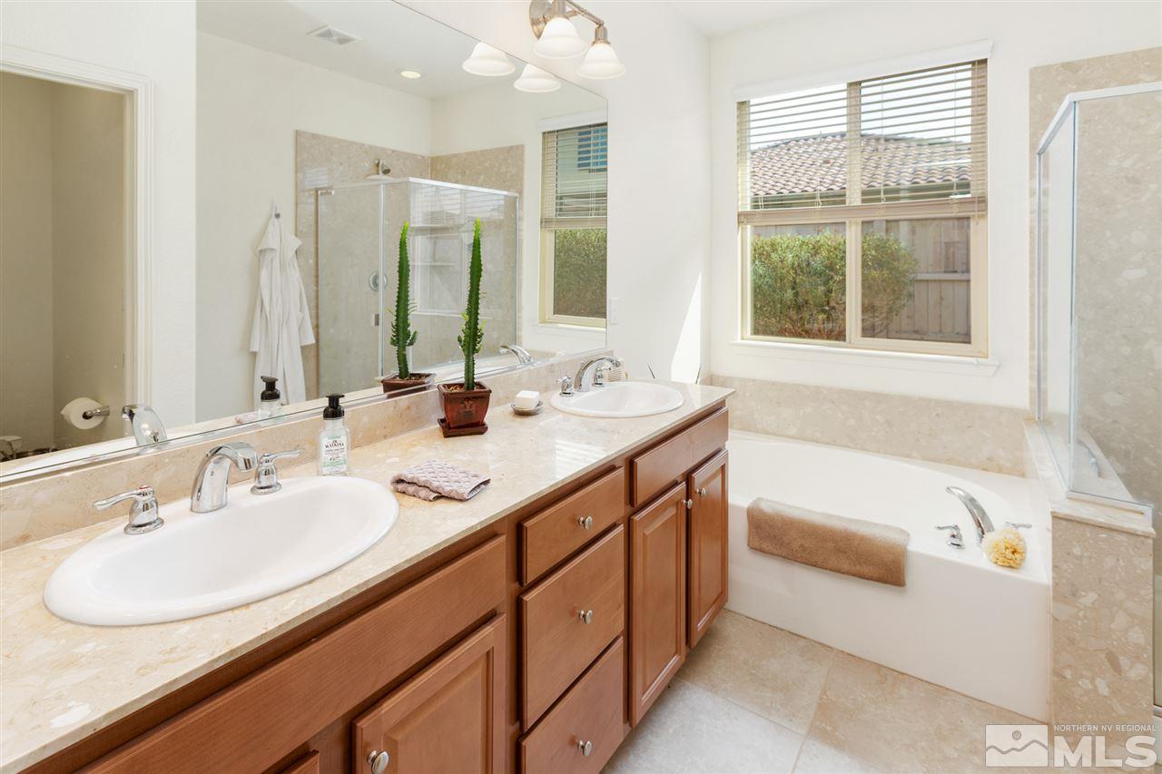 10800 Pebble Hill Drive Reno, NV 89521 - Photo 10 of 21 a bathroom with a double vanity sink and a bathtub