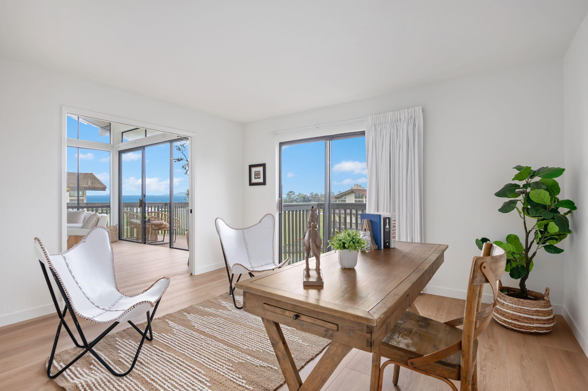 3375 Foothill Road, Unit 231 Carpinteria, CA 93013 - Photo 23 of 28 a dining room with furniture potted plants and wooden floor