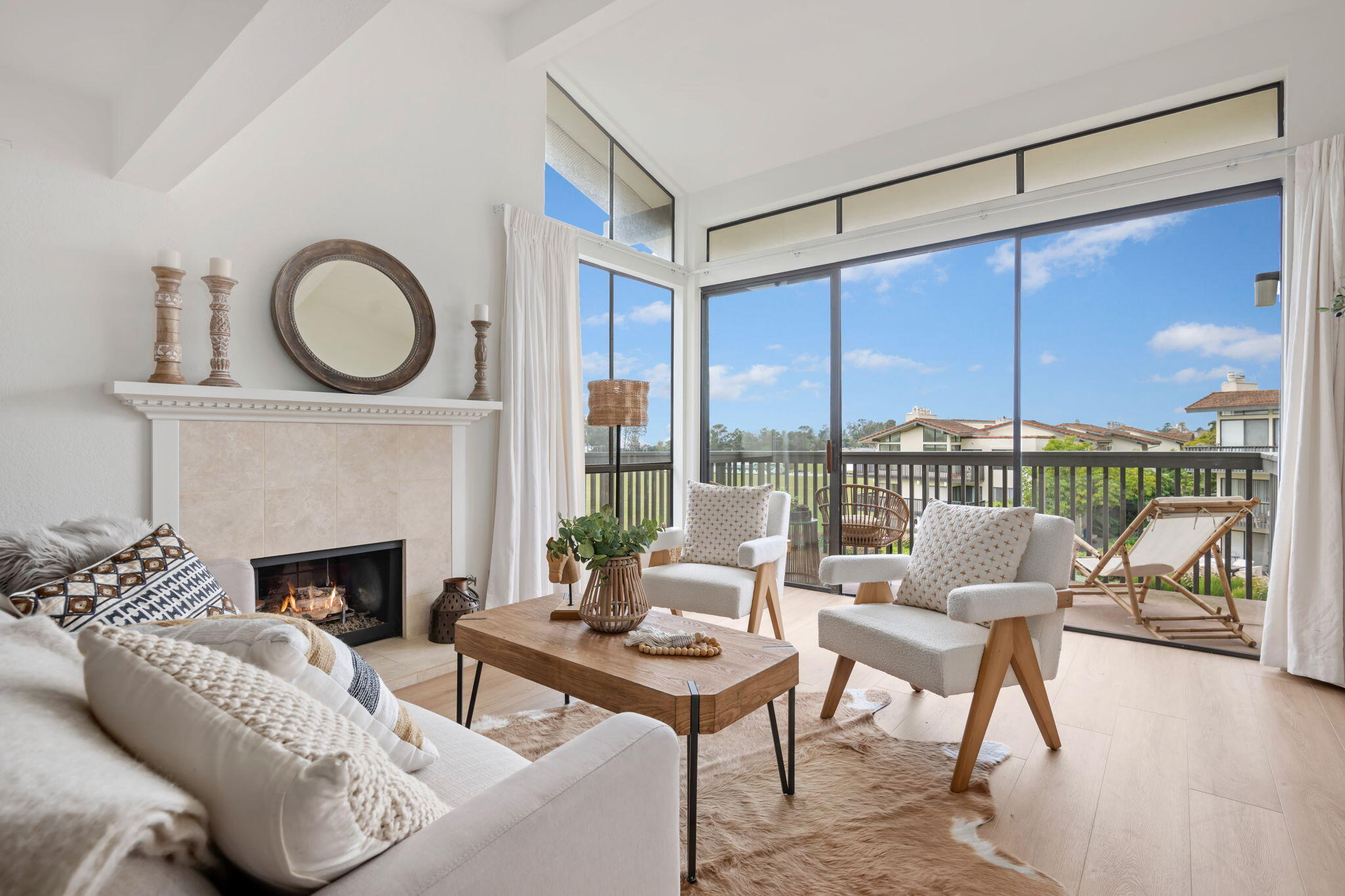 3375 Foothill Road, Unit 231 Carpinteria, CA 93013 - Photo 4 of 28 a living room with furniture a fireplace and floor to ceiling window