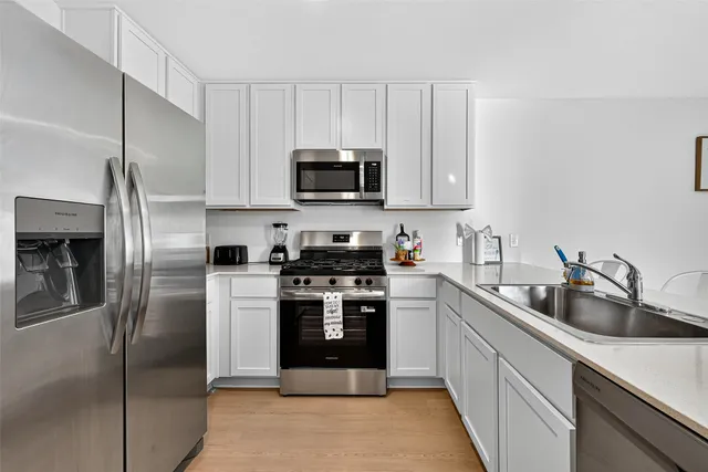 a kitchen with sink and natural light