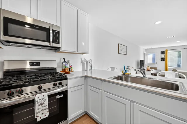 a view of a living room with furniture and wooden floor
